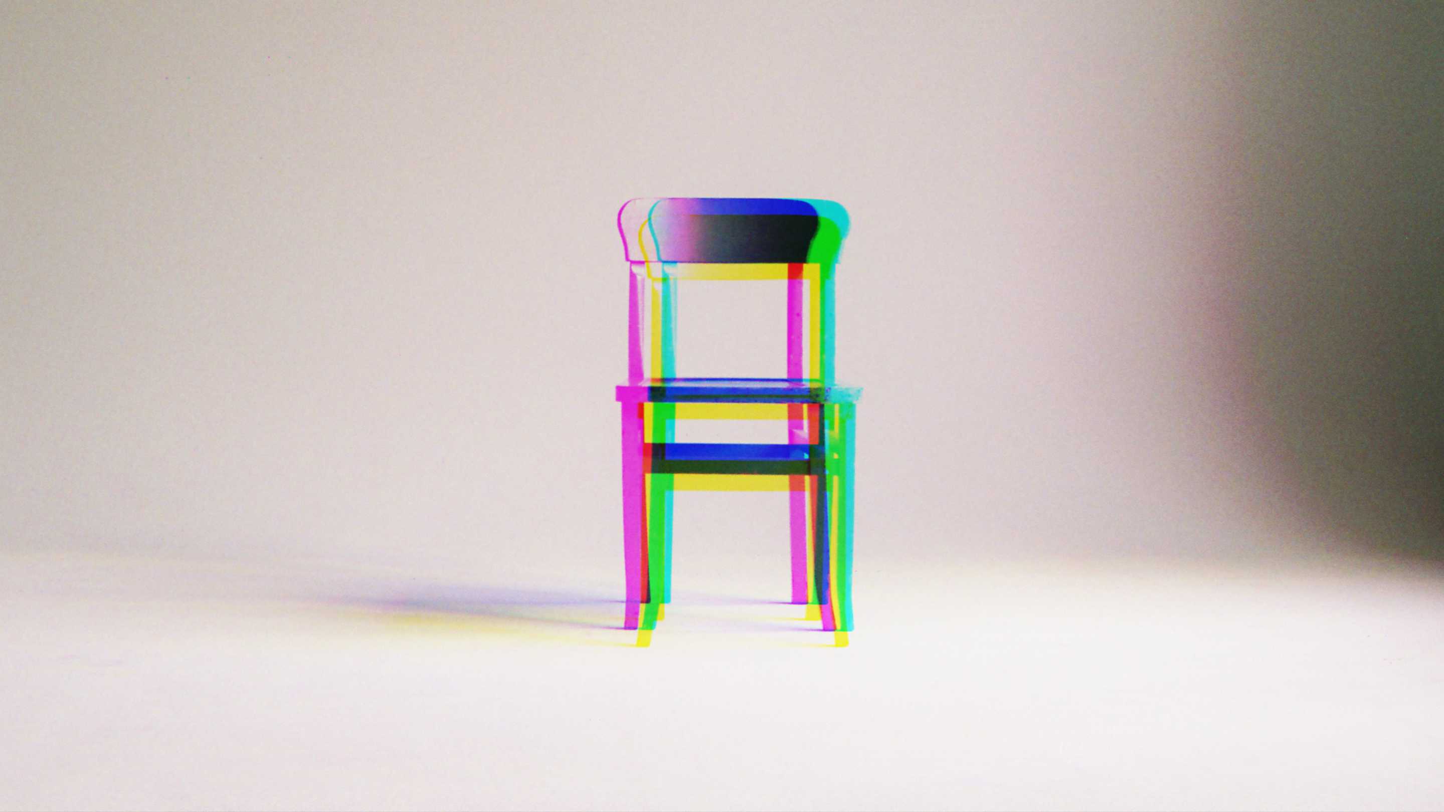 wooden chair with prism effect against a plain background